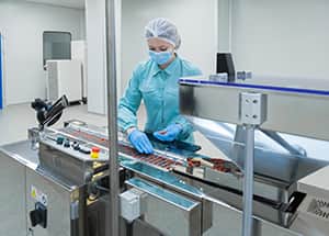 Worker with facemask on assembly line