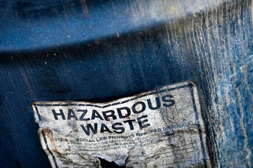 Drum of hazardous waste in open field